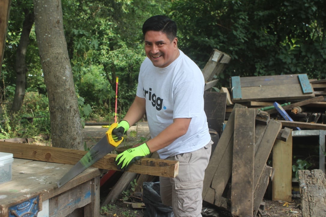 Team sawing wood to build structures