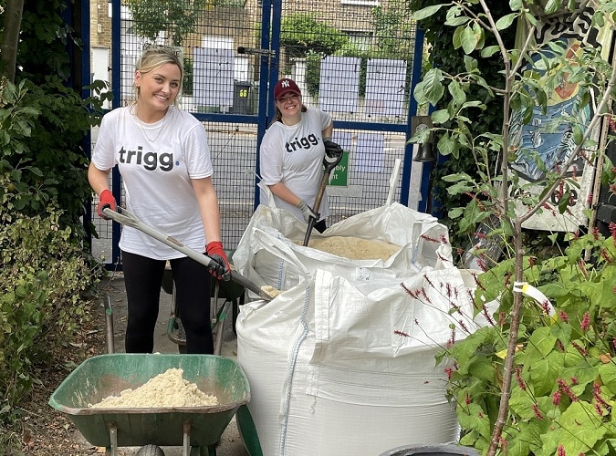 Team filling wheelbarrows with sand